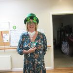 A woman in St Patricks Celebratory glasses and hat