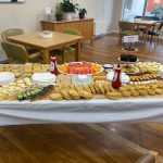 A spread of mixed bakery goods and fresh fruit with gluten free options
